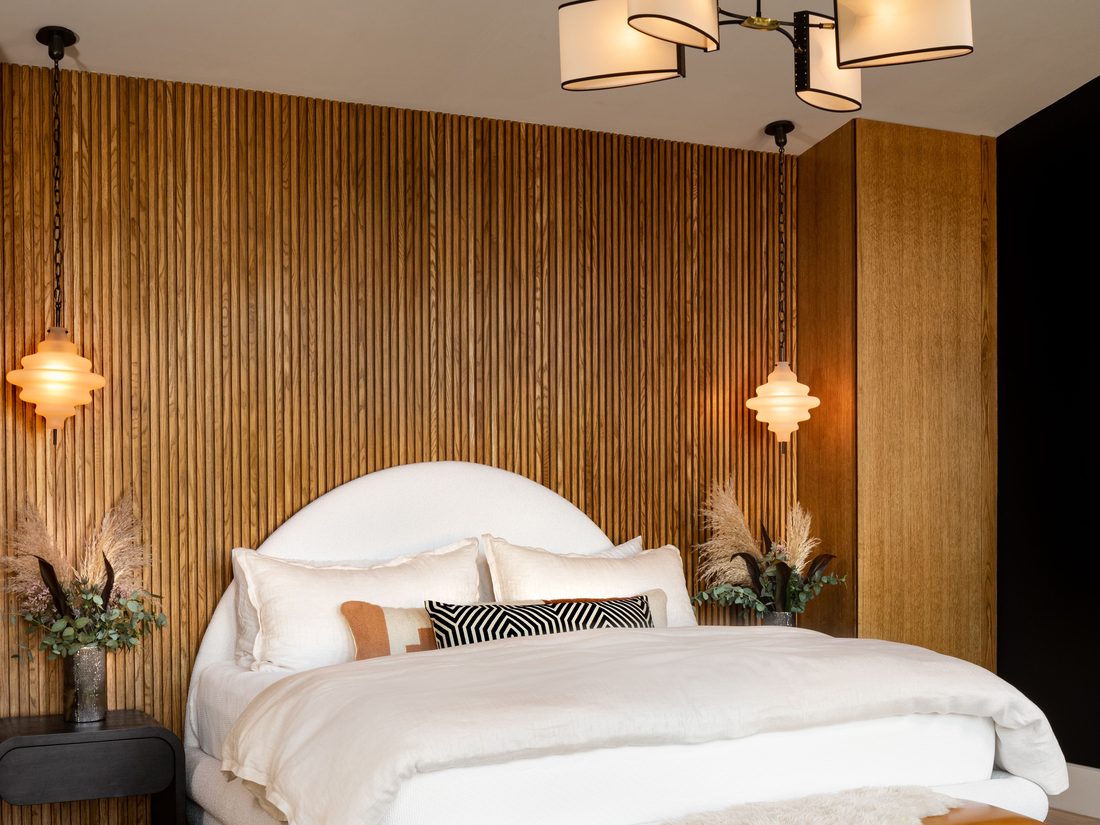 Bedroom accent wall finished with elegant patterned wallpaper